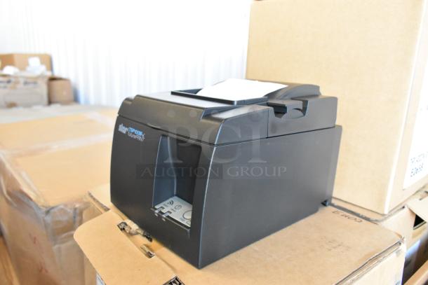 Brand new Star TSP100III receipt printer, black, on cardboard box. Includes Cradlepoint Router. 5 items total in lot.