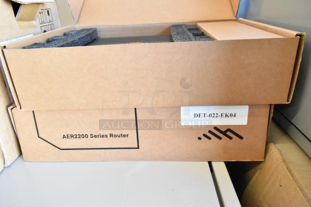 Brand new AER2200 Series Router in box with label "DET-022-EK04." Part of a lot including Star TSP100III Printer.