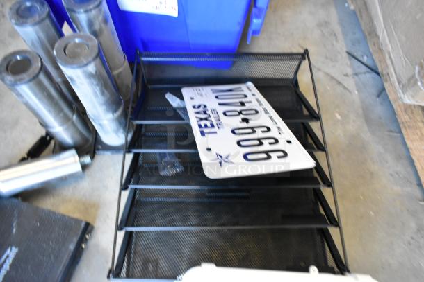 2 poly bins containing various items, including metal legs, license plate, and shelving unit. Items appear used and varied.