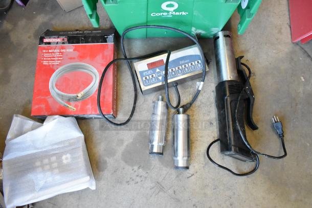 Two poly bins containing various items: wires, legs, a router, tape dispenser, timer; bids double. Box for a 10ft Universal gas hose also visible.