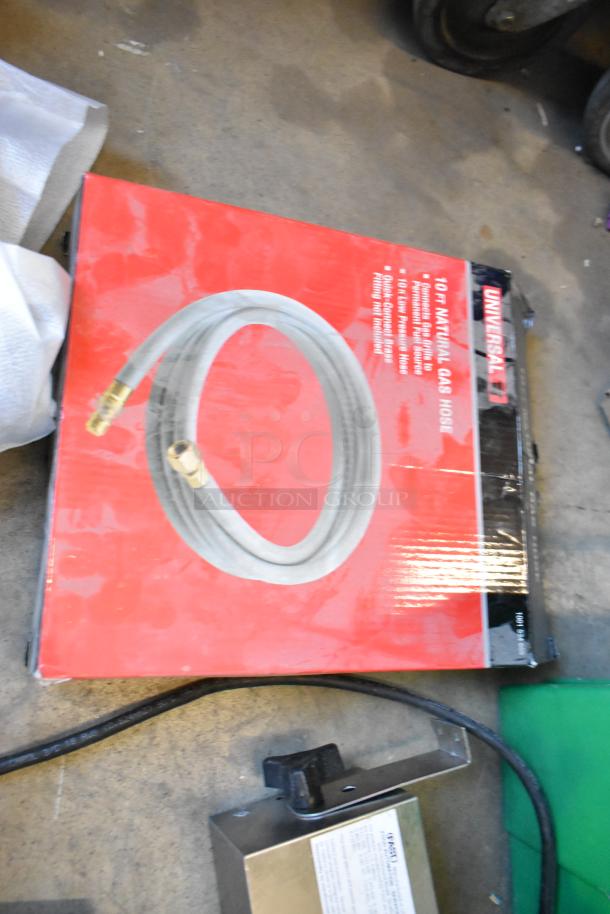 Two poly bins containing wires, table legs, router, tape dispenser, and timer. Includes marked Universal 10ft gas hose.