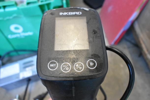 Inkbird device with worn condition, visible buttons for settings, in an auction lot with wires, legs, and more items.