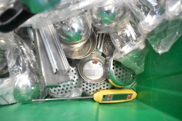 Two green poly bins with assorted metal items, wires, router, tape dispenser, and a digital timer.