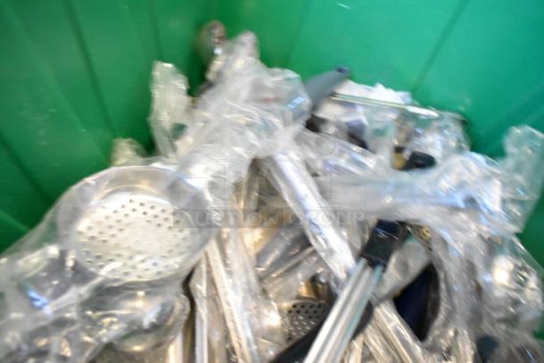 Two poly bins with assorted items including wrapped wires, metal rods, and a perforated metal piece; no visible labels.