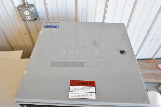 Brand new Power Assemblies gray metal box with labels. Features a locking mechanism and warning tag. Pristine condition.