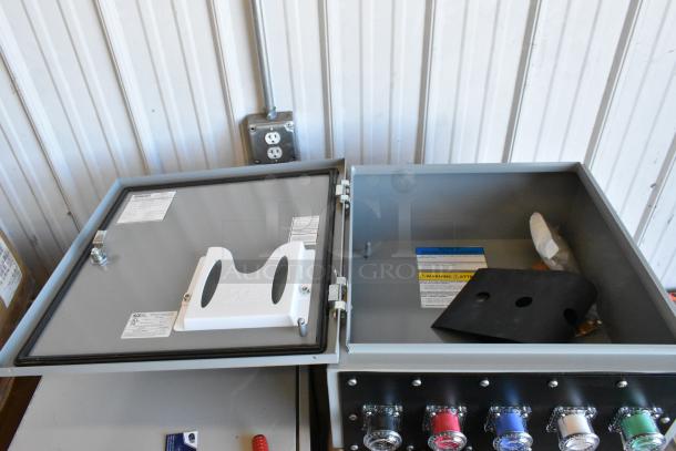 Brand new Power Assemblies gray metal box, open with internal components, safety labels, and visible brand markings.