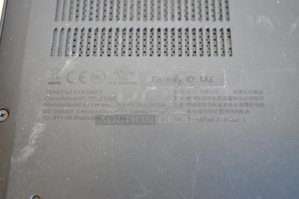 Close-up of a Lenovo ThinkPad X13 Gen 1 laptop bottom panel, showing compliance ID: TP00106C and factory ID: MJ.