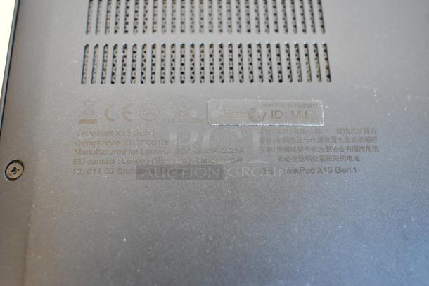 Back of Lenovo ThinkPad X13 Gen 1 laptop showing compliance ID, manufacturing details, and factory ID.