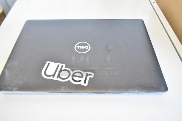 11 mixed Lenovo ThinkPad, Dell, HP laptops, visible Dell with "Uber" sticker, in used condition. Bid for all.