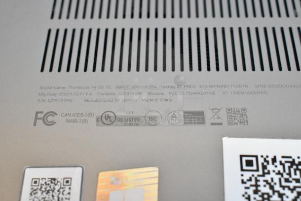Close-up of Lenovo ThinkBook 14 G2 laptop bottom panel, showing model details, factory ID, and certification logos.
