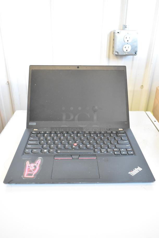 Lenovo ThinkPad X13 laptop, black, sticker on palm rest, visible Lenovo and ThinkPad logos, good condition.