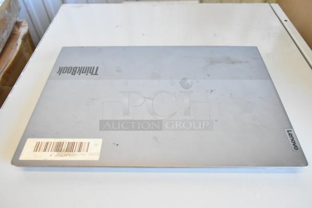 11 Lenovo ThinkPad, Dell, HP laptops on auction. Visible wear, includes barcode label indicating LAPTOP 4.