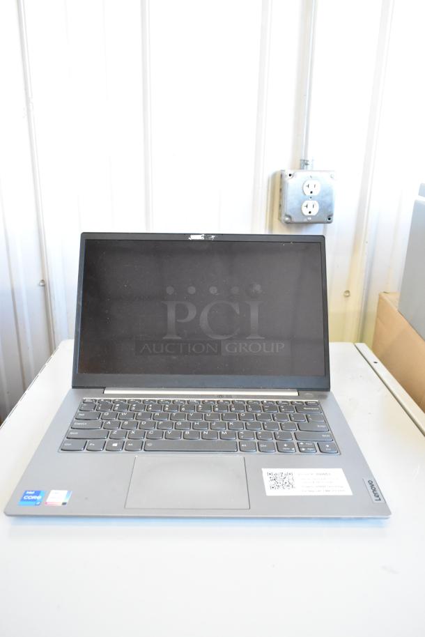 Lenovo ThinkPad laptop, silver finish, visible Intel Core sticker, near pristine condition, offering modern functionality.