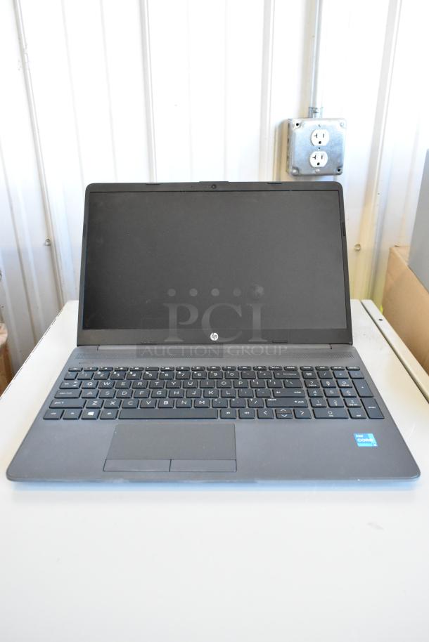 HP laptop featuring Intel Core processor, matte black finish, full keyboard, in good condition. Part of 11 laptop auction.