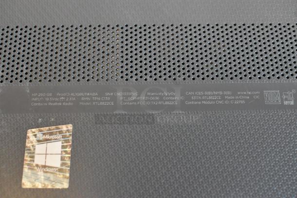 Label on HP 250 G8 laptop showing product ID, serial number, input voltage, and Realtek radio model. Microsoft Windows sticker visible.