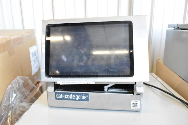 Date Code Genie DCGX2 Label Printer, silver casing, touchscreen, moderate wear, branding visible. Ideal for label printing.
