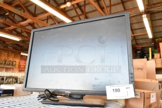 Dell U2412Mb monitor in used condition, visible loose cables, and auction tag number 190 attached.