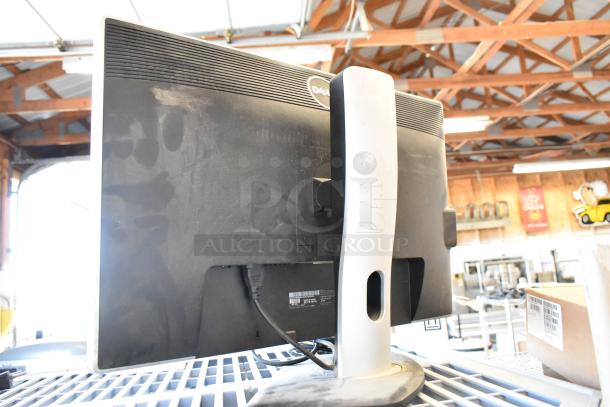 Dell U2412Mb computer monitor with signs of wear; visible markings on the stand; sold as-is.