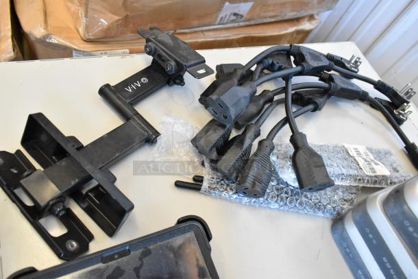 Lot of various electronic items including cables, mounts, and packaged equipment. Visible label reads "VIVO." Mixed condition.