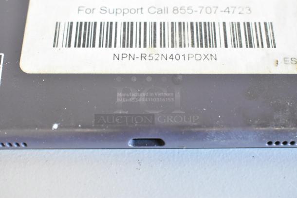 Close-up of a tablet showing a barcoded label with item code NPN-R52N401PDXN. Engraving reads "Manufactured in Vietnam."