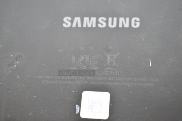 Six various tablets, including Samsung model SM-T387V. Back panel shows Samsung branding and manufacturing details.
