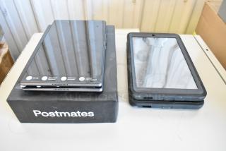 Five Samsung and Lenovo tablets, mixed models, on a table. Some show wear. Postmates box included. Features visible labels.