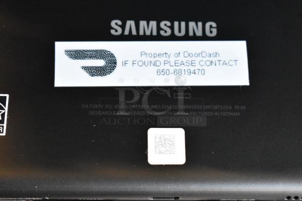 Samsung device model SM-T387V with DoorDash property tag and contact info. "Designed by Samsung" marking visible.