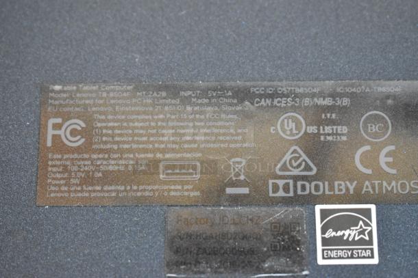 Rear view of a Lenovo TB-8504F tablet showing regulatory labels, FCC ID, and Energy Star certification.