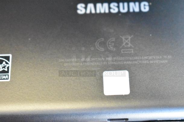 Five various tablets including a Samsung model. Samsung markings indicate model SMT387V, CE certification, made in Vietnam.