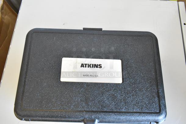 Black hard case labeled "ATKINS, Made in U.S.A." for 3 Atkins AquaTuff 351 thermometers, showcased closed.