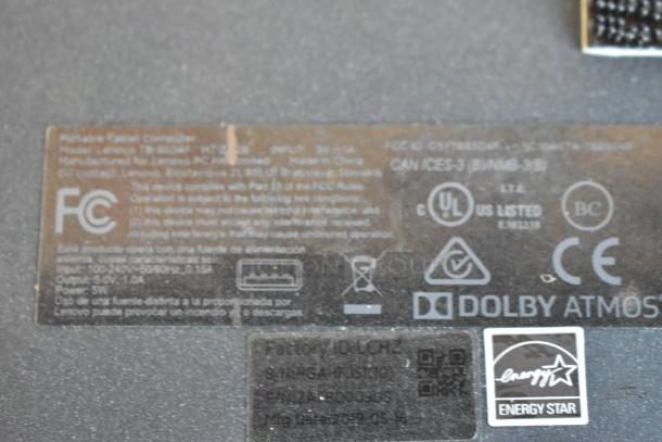 Label on Lenovo device showing FCC compliance, power input details, manufacturer information, and Energy Star logo.