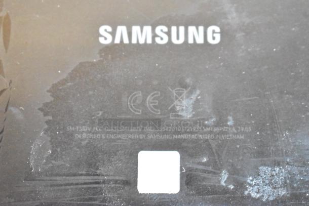 Samsung label on a black surface, indicating model SM-T387V. Minor wear visible. Manufactured in Vietnam.