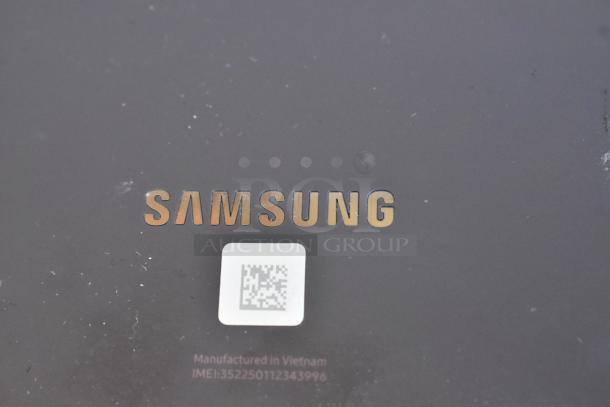Samsung logo on a table, with "Manufactured in Vietnam" and an IMEI number visible. Minor wear on the surface.