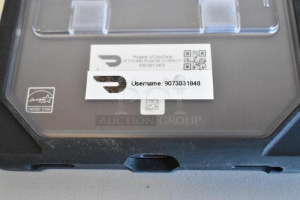 Auction item image showing a Samsung Energy Star labeled tablet with DoorDash property label and QR code.