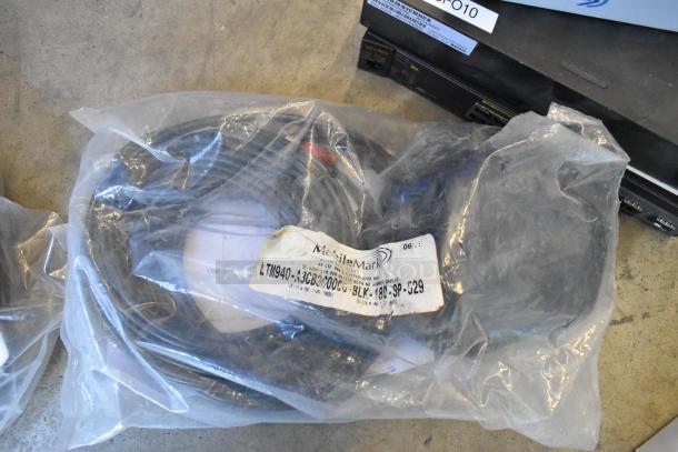 Lot of items including wires in a plastic bag with a label marked "LTM1940" and electronics. Condition: mixed.