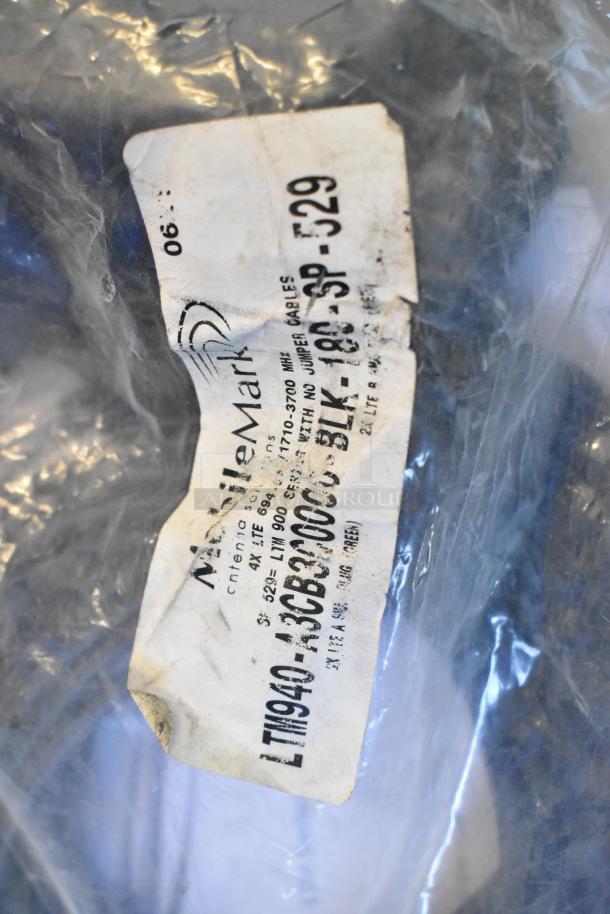 Clear plastic bag labeled "Mobile Mark." Contains various items, visible text includes "LTN940-A3CB3000." Bag condition is worn.