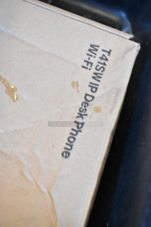 Lot includes gas detector, wires, Verizon corded phone. Box labeled "T41SW IP Desk Phone Wi-Fi." Visible stains present.