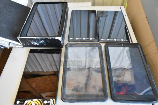 Six various tablets, including Samsung, with visible screens and cases, mixed conditions. Boxed and unboxed in auction.