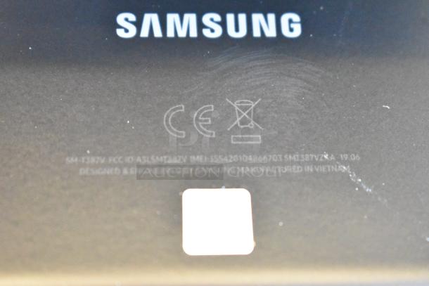 Close-up of a Samsung tablet back with logo and manufacturing details visible. Model SM-T387V.