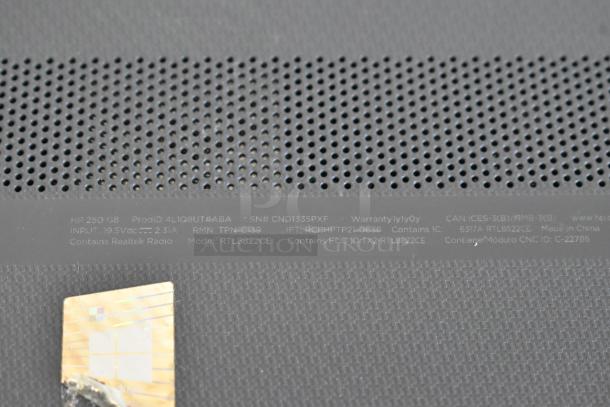 Close-up of an HP 250 G8 laptop bottom panel, showing model info and serial number details, with a Windows sticker visible.