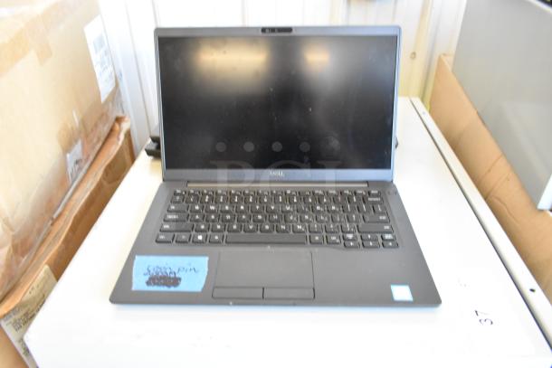 Dell laptop with black keyboard, blank screen, and a blue sticky note on touchpad. Part of a 5-laptop auction lot.