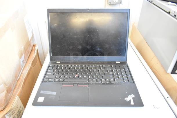 Five assorted laptops including Dell and HP. Visible is a Lenovo ThinkPad laptop, possibly used, with a black keyboard.