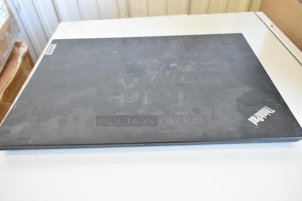 An assortment of five laptops, including prominent brands Dell and HP, displayed together. Some wear is visible.
