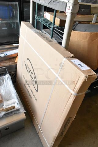 "Brand new Yukon 120-YWTG3024418 stainless steel worktable in box, features durable construction, ideal for workspace."