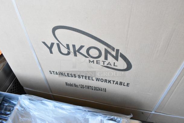 Brand new Yukon 120-YWTG3024418 stainless steel worktable, in box, with model number visible on packaging.