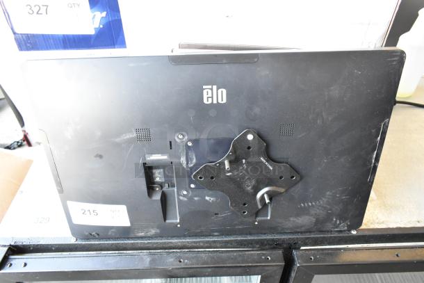Three black Elo monitors, back view, with mounting brackets. Some surface wear visible. Auction item label: 215.
