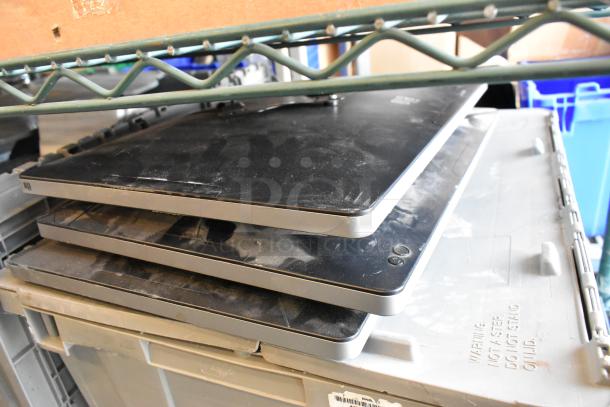 Three Elo monitors stacked, moderate wear, no visible screens. Housed on a shelf, some dirt present. Ideal for bulk bidding.