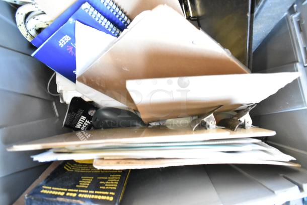 Lot of various items in poly bin, including a gas monitor and Dymo LetraTag. Assorted office supplies visible. Mixed condition.