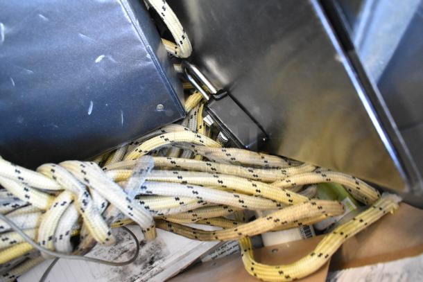 Lot of various items including a gas monitor, Dymo LetraTag, coiled rope, and metal box in a poly bin. Mixed condition.