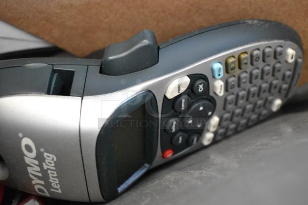 Dymo LetraTag label maker in a poly bin with keypad and screen, part of assorted item lot, good condition.
